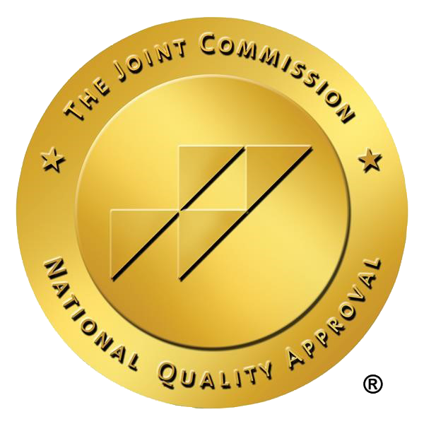 Icon of a gold seal logo, representing excellence and high standards, featuring an embossed design with a ribbon, used by Reliant Healthcare Coeur d'Alene to symbolize their commitment to quality care.