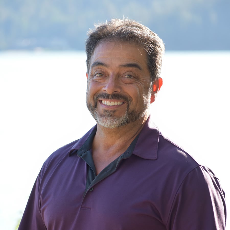 Professional headshot of Mike Gallegos, featuring him smiling in business attire, set against a light background, representing his role at Reliant Healthcare Coeur d'Alene.